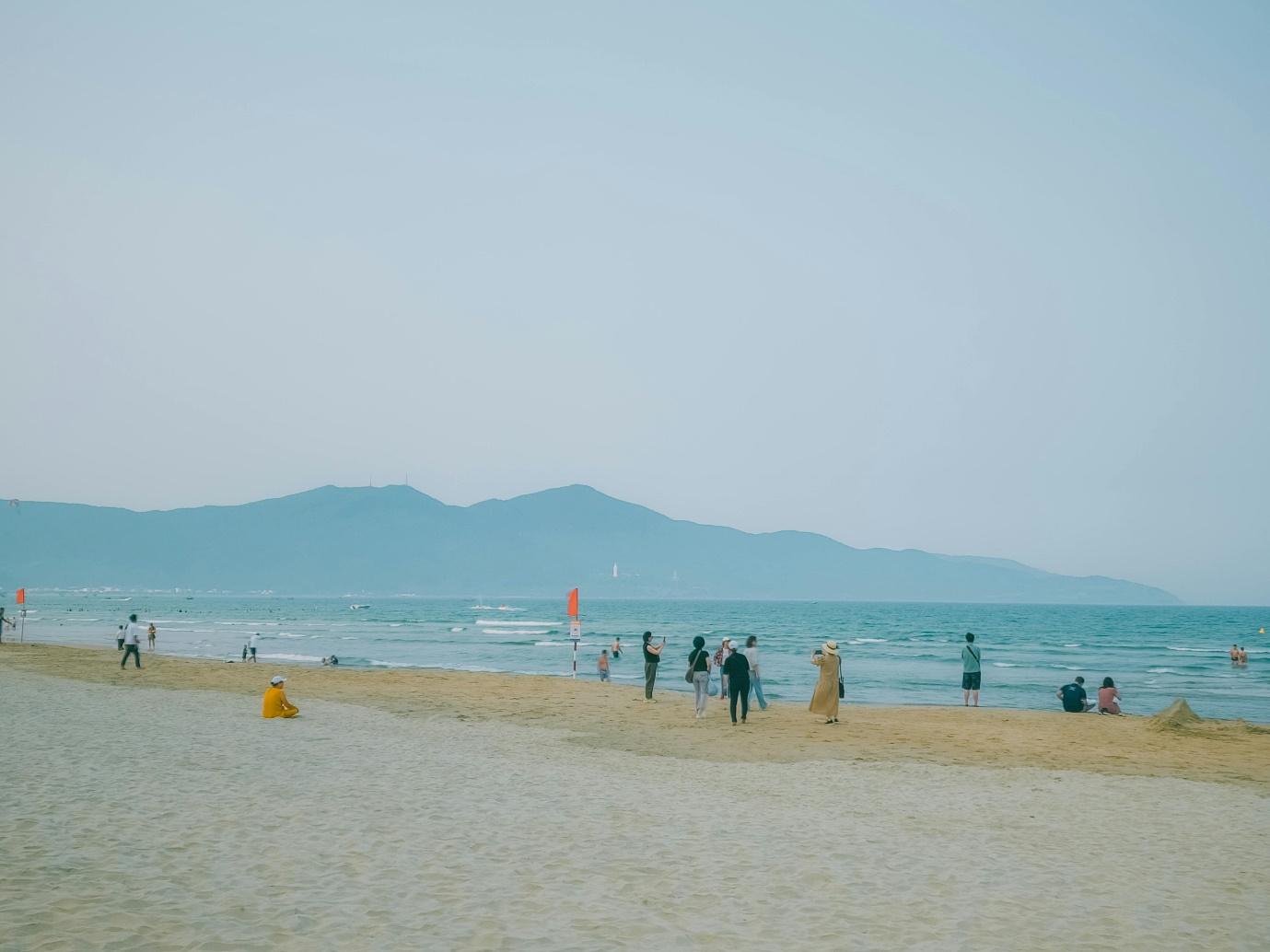 A group of people on a beach AI-generated content may be incorrect.
