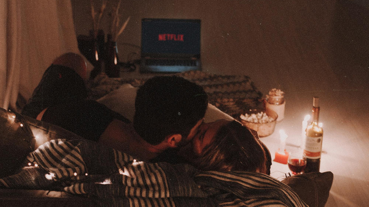 couple snuggling up on a spooky Halloween date night