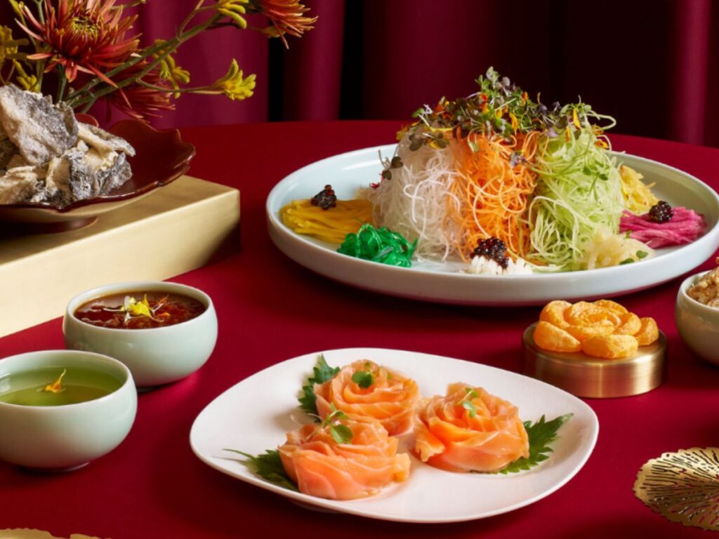 Salmon slices and abalone added to Lo Hei Yu Sheng during Chinese New Year tradition