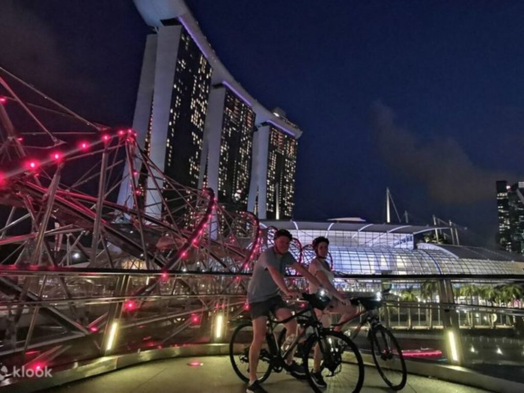Fun date ideas in singapore for couples cycling at Marina Bay skyline at night