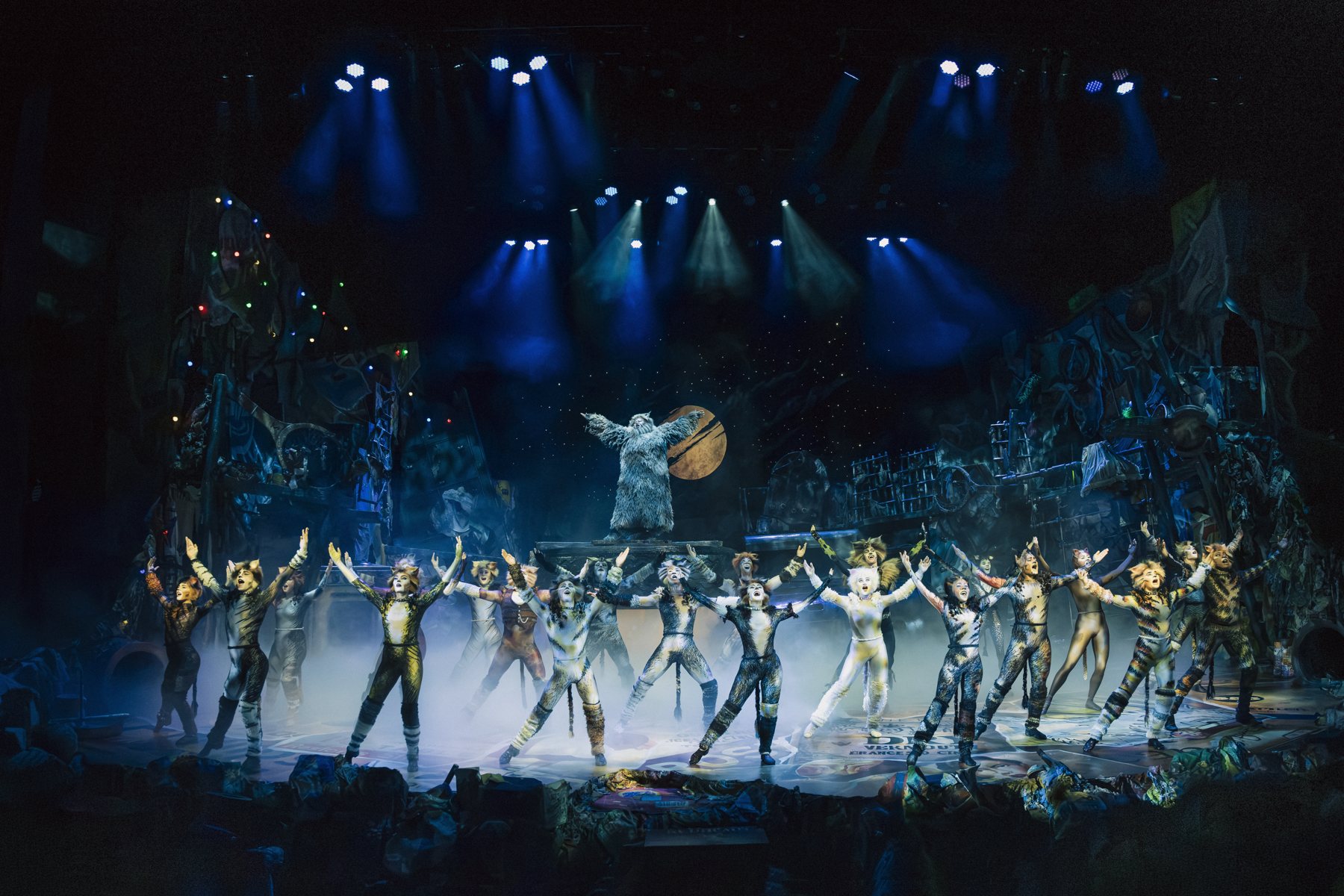 The Jellicle Cats gathered in fog before Old Deuteronomy on the junkyard set of Cats the Musical at Sands Theatre, Singapore