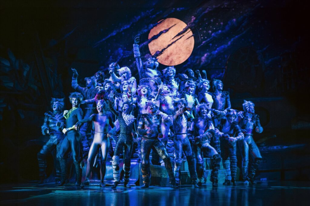 The Jellicle Cats singing together under the moon in Cats the Musical