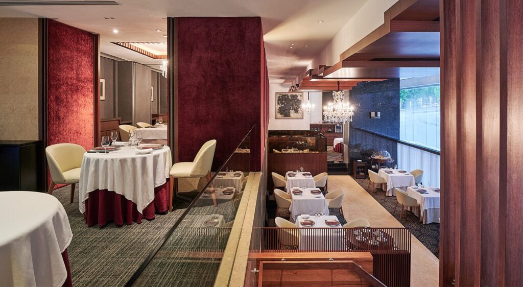 The Les Amis dining room with velvet walls and chandeliers
