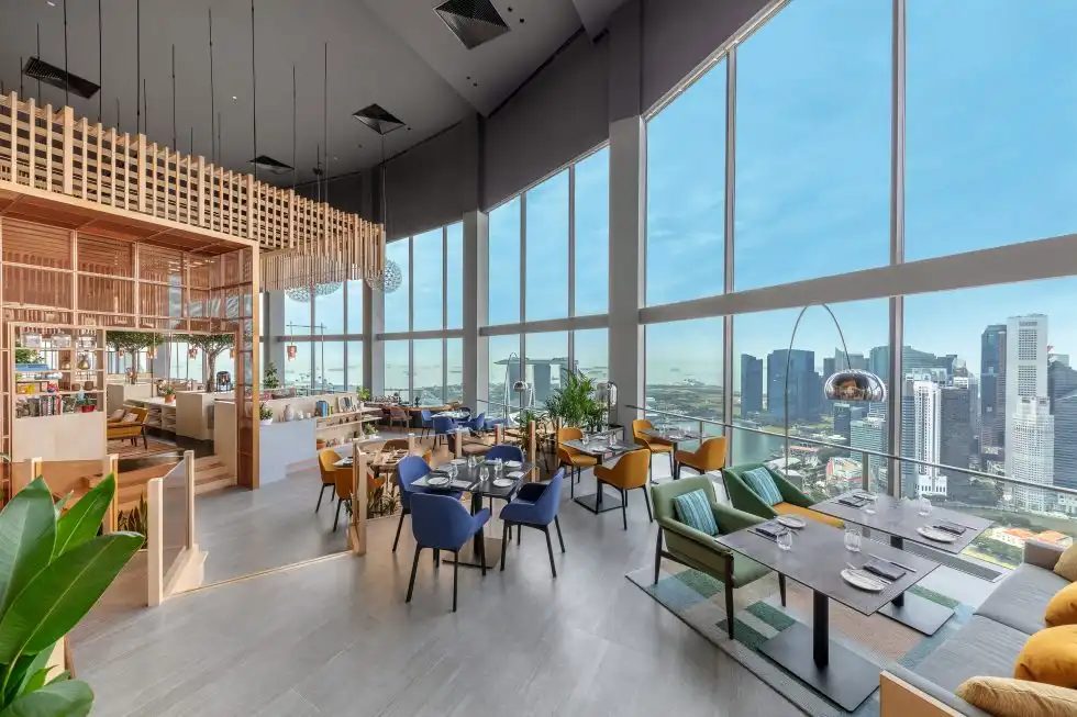 SKAI dining room with floor-to-ceiling windows over the Singapore skyline