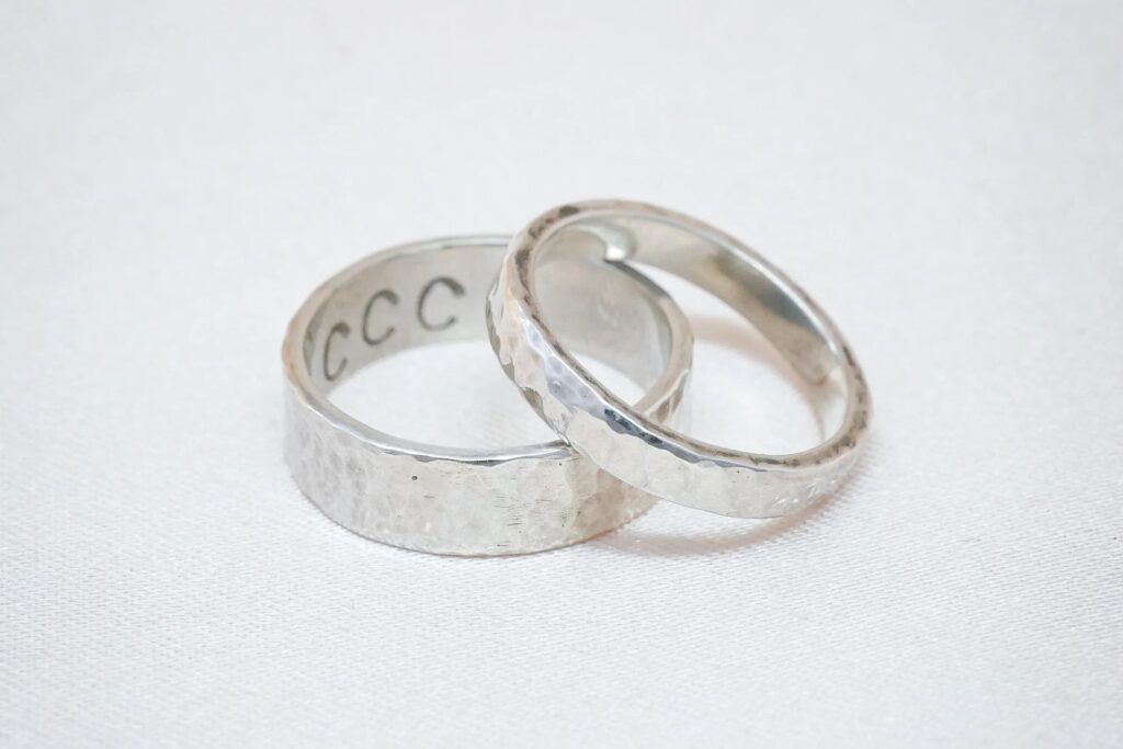 A pair of stamped silver ring bands made at the Clink Clank Clunk ring band workshop