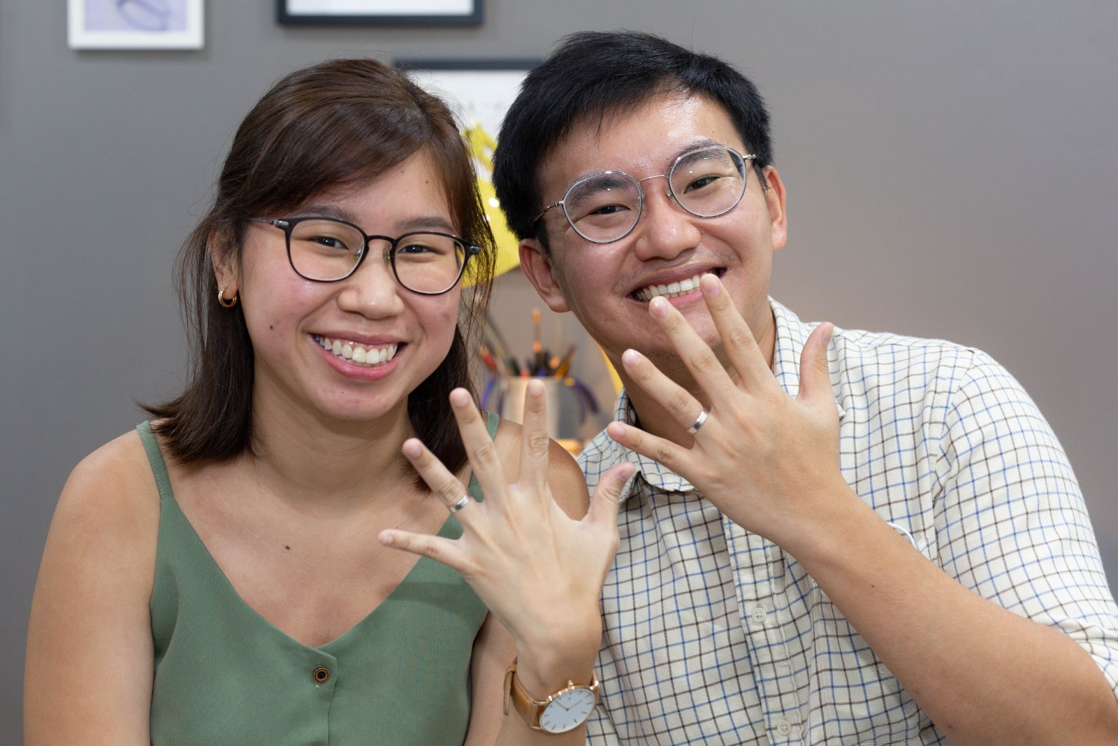 A couple admiring the silver rings they made at a ring making workshop in Singapore