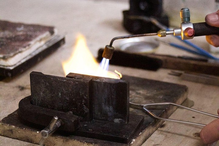 Soldering silver with a torch at The Imperial Smithster silversmithing workshop in Joo Chiat