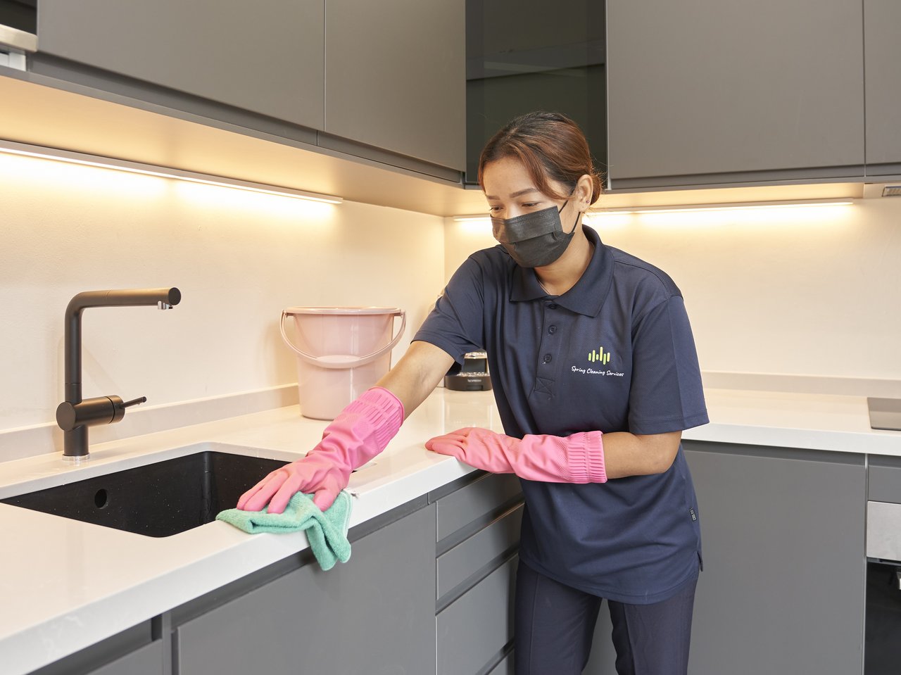 Spring Cleaning Services cleaner wiping a kitchen counter after renovation